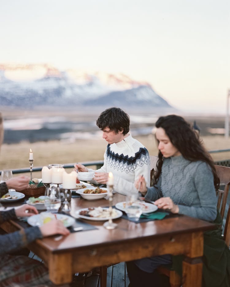 Man And Woman Eating Dinner On Patio