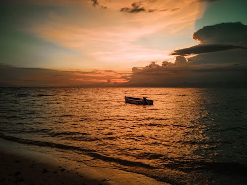 A Boat on the Sea during Sunset