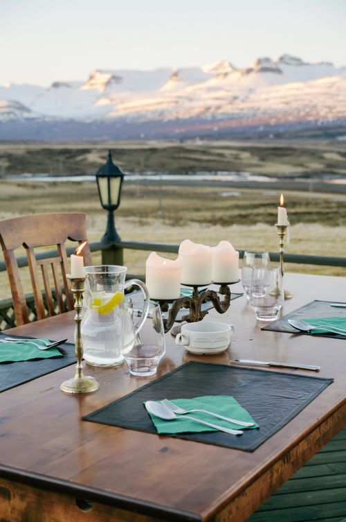 Free Beautiful dining setup with candles and snow-capped mountains in view. Stock Photo