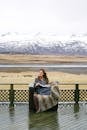 Woman with Book and Mountains in Background