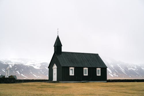 A Black Church with Mountains in the Background