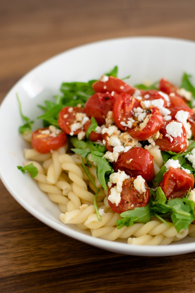 A Pasta With Tomatoes On Ceramic Bowl