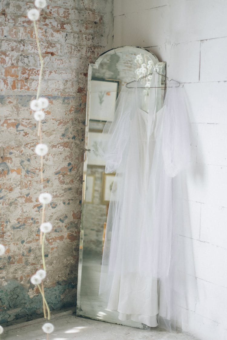 White Chiffon Dress Hanging On Stand Mirror