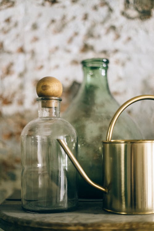 Stainless Steel Teapot and Clear Glass Bottle