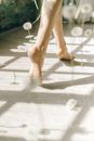 A Person Walking Barefoot and Dandelions Floating in Midair