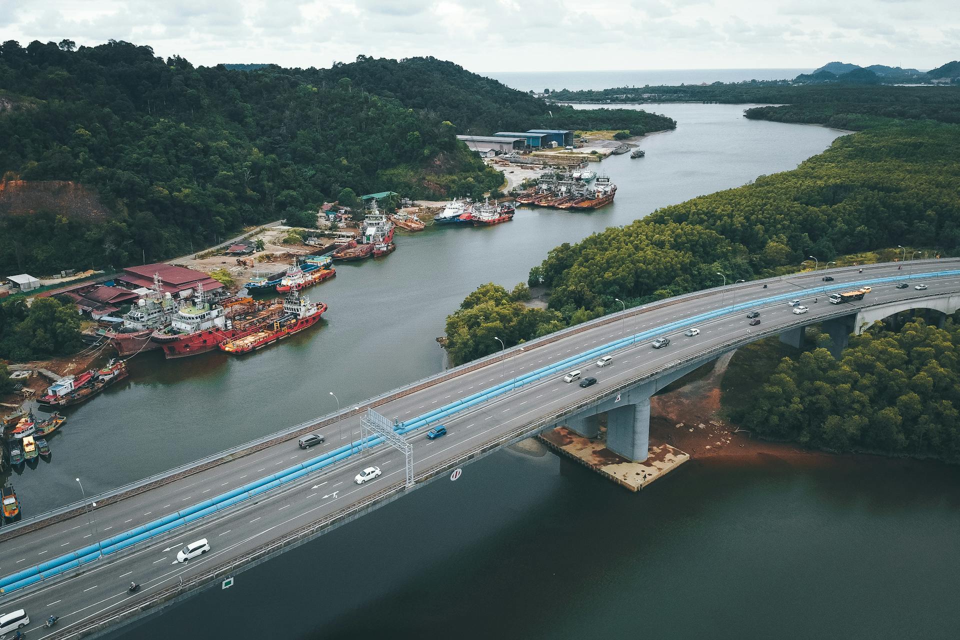 Port with ships near bridge over river