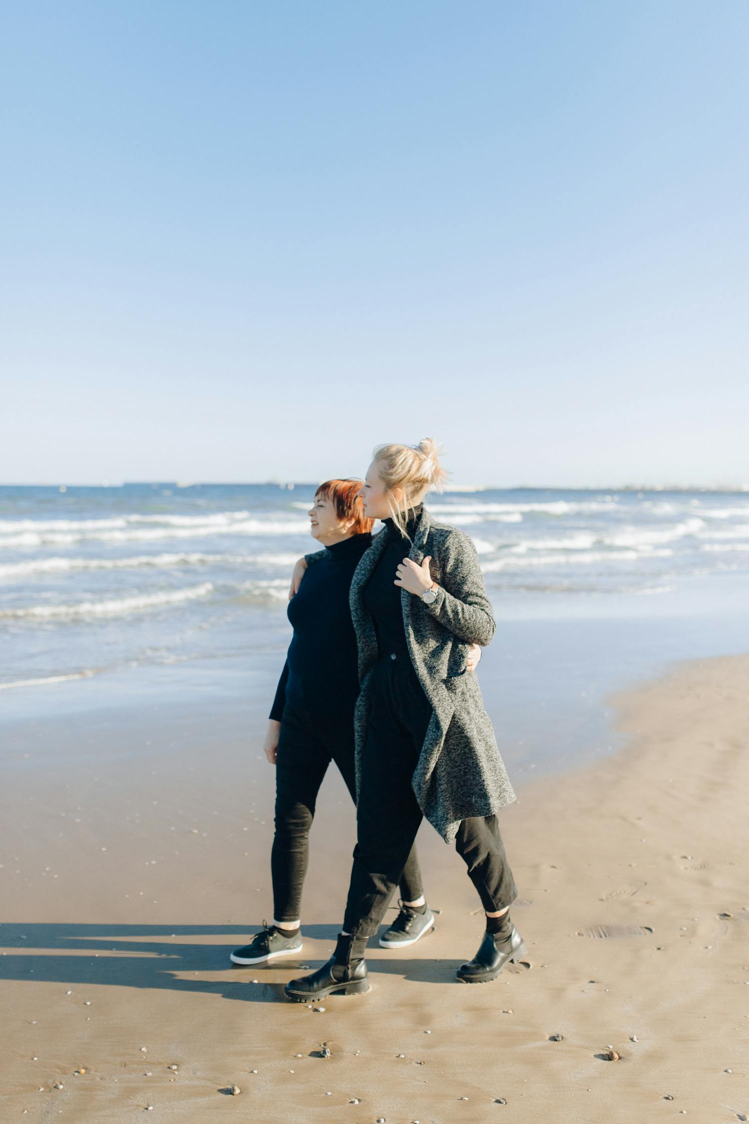 Woman in Black Coat Standing on Beach · Free Stock Photo