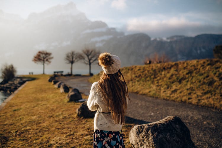 Woman In Beige Sweater Standing On A Park