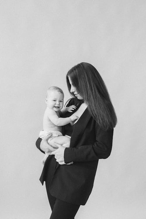 Woman in Black Blazer Carrying Baby 