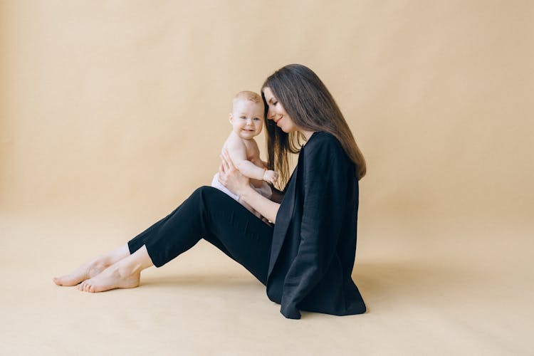 A Woman Holding A Baby 