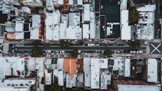 Cars driving through suburb area between residential buildings
