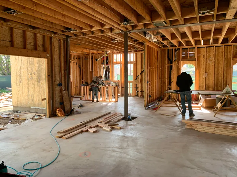 Builders at work on a new home, illustrating how to vet a home builder