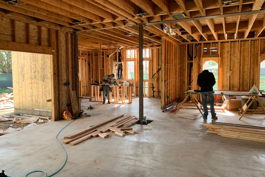 Workers constructing a house framework