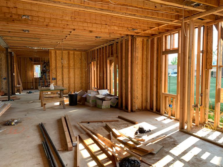 Residential interior under construction with exposed wood framing