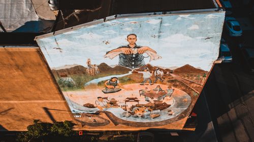Free From above of creative artwork on wall of old shabby building in town in daylight Stock Photo