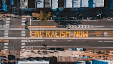 Roadway with END RACISM NOW title in town