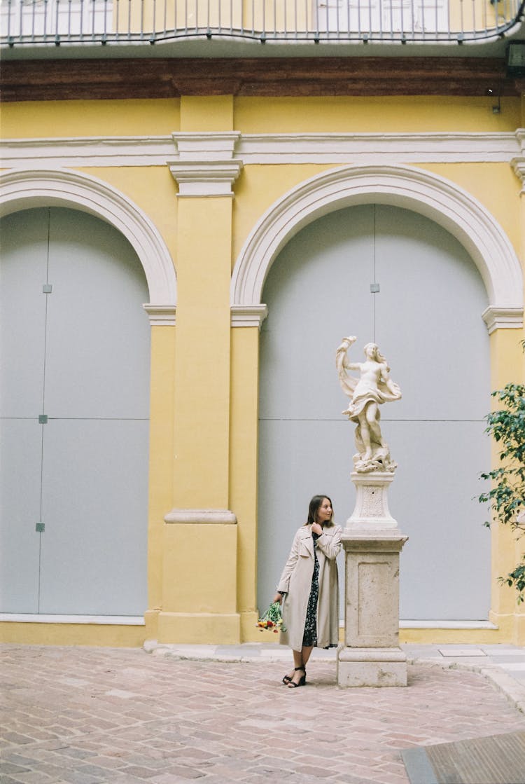 A Woman Leaning On A Statue