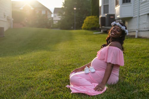 A Pregnant Woman Sitting on the Ground