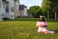Woman Sitting on Grass in Dress