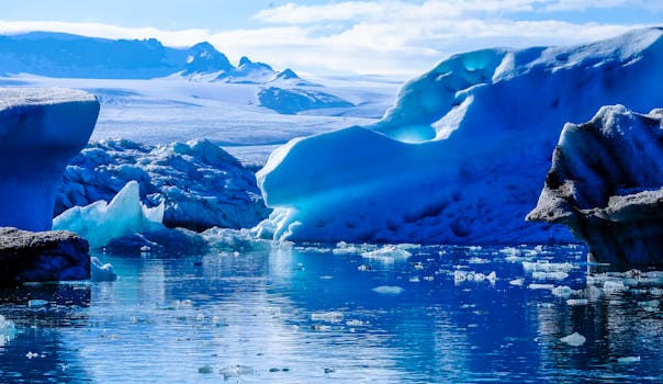 Scenic View Of Frozen Lake Against Blue Sky Free Stock Photo