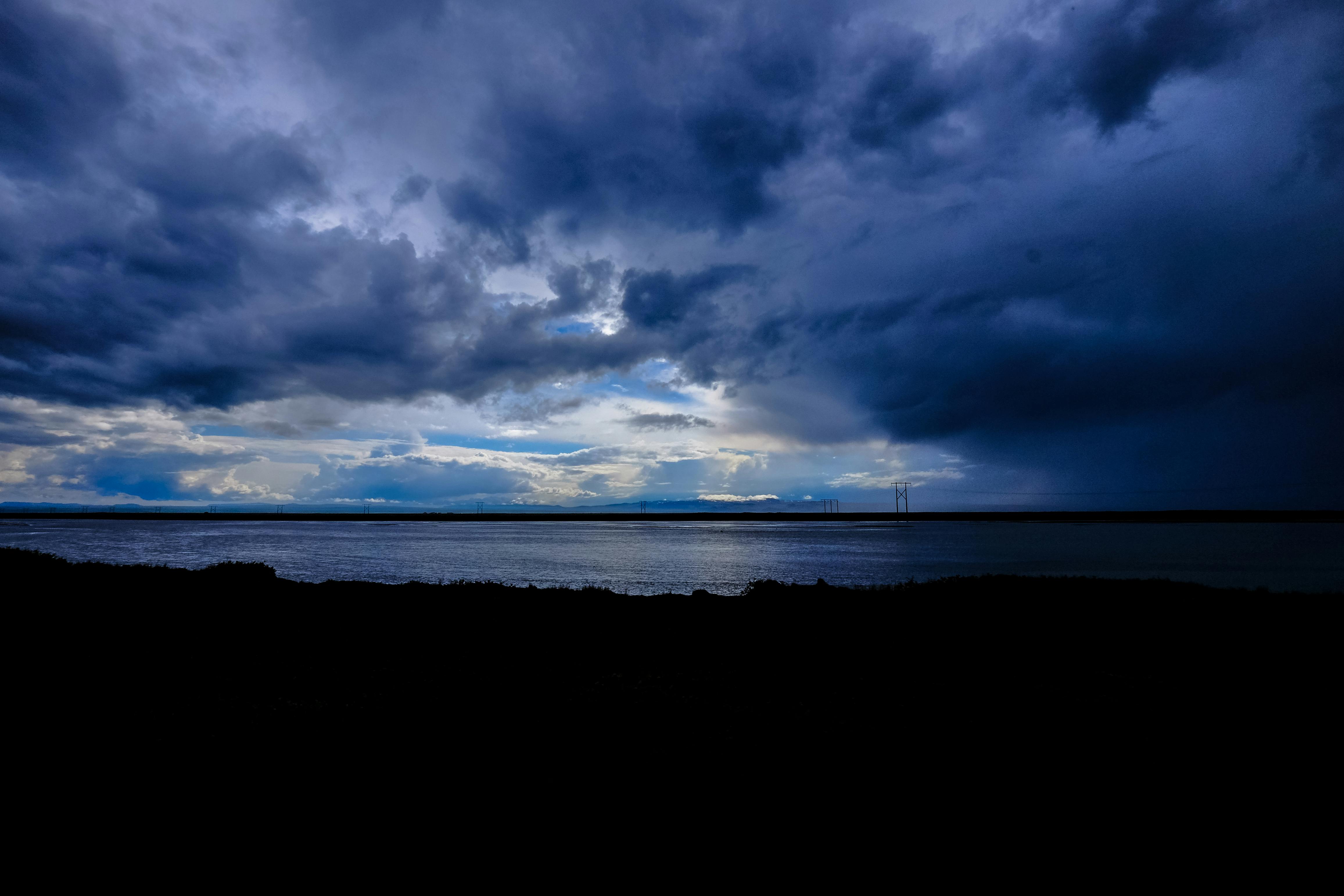 Brown Mountain Beside a Sea Under Grey Cloudy Sky Â· Free ..., free happy birthday ocean images