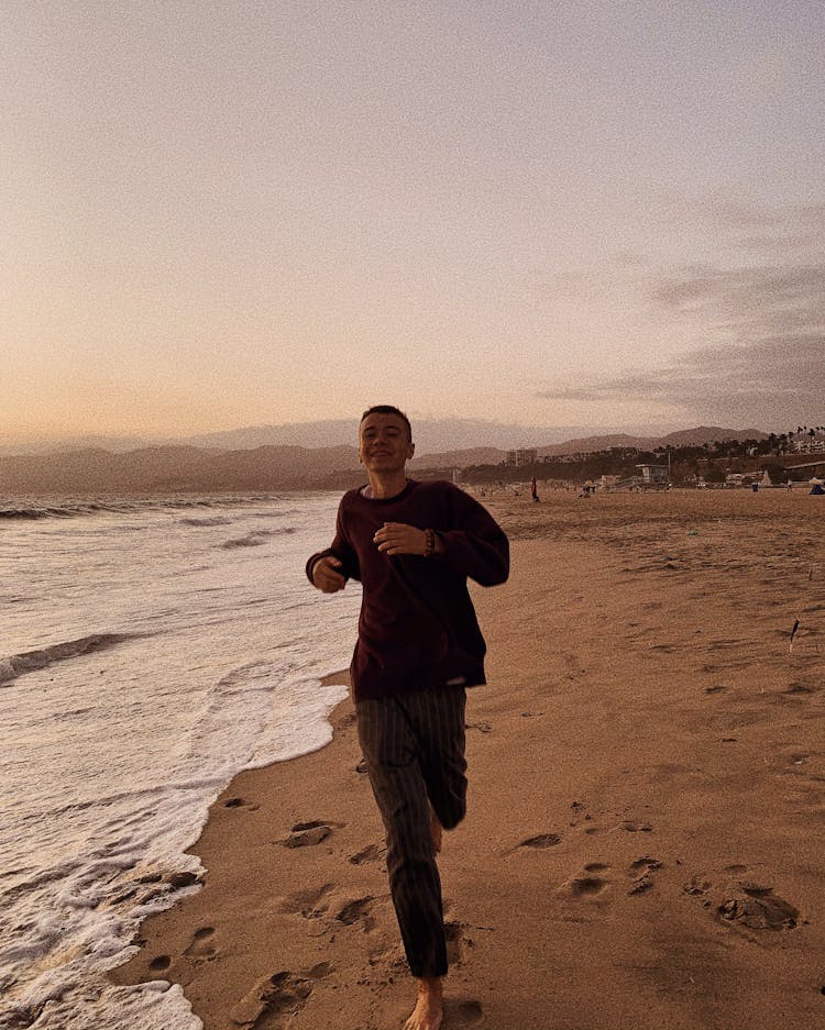 Happy Man Running On Beach