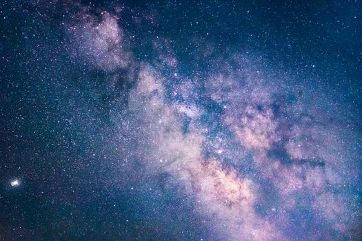 Capture of the Milky Way galaxy illuminating the night sky over München's scenic landscape.
