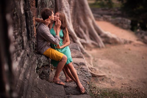 Free A Couple Kissing Outside a Building Stock Photo