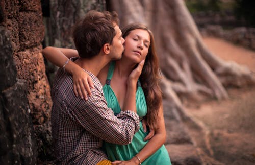 A Man Kissing a Woman on her Cheek
