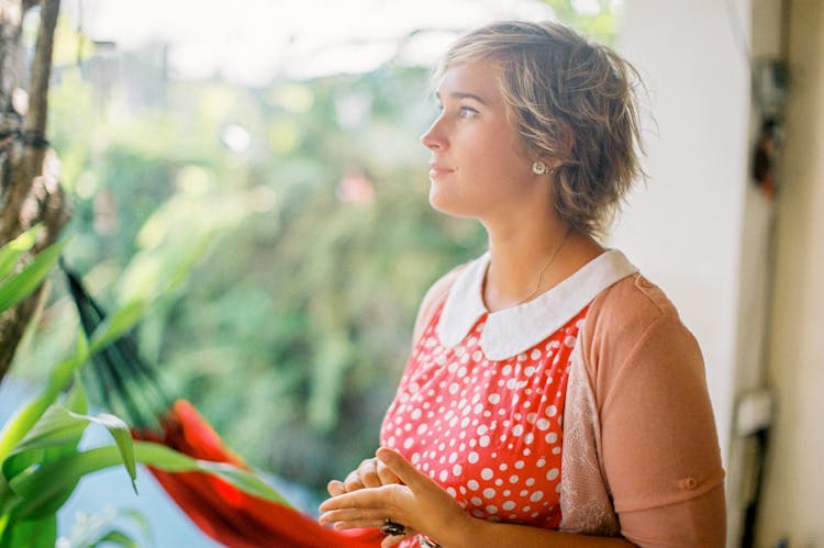 A Woman In Orange And White Polka Dot Top