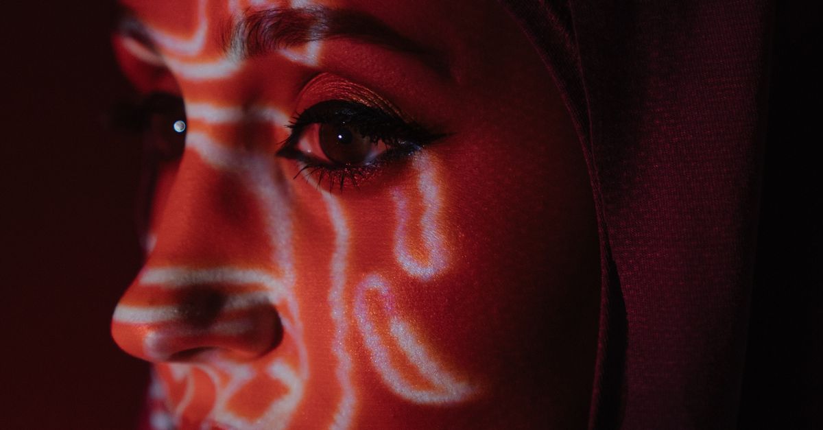 Woman With Red Face Paint · Free Stock Photo