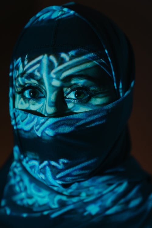 Person in Black Hijab and Teal Scarf