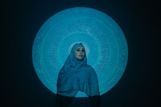 Woman in Blue Hijab Standing Beside Blue and White Wall