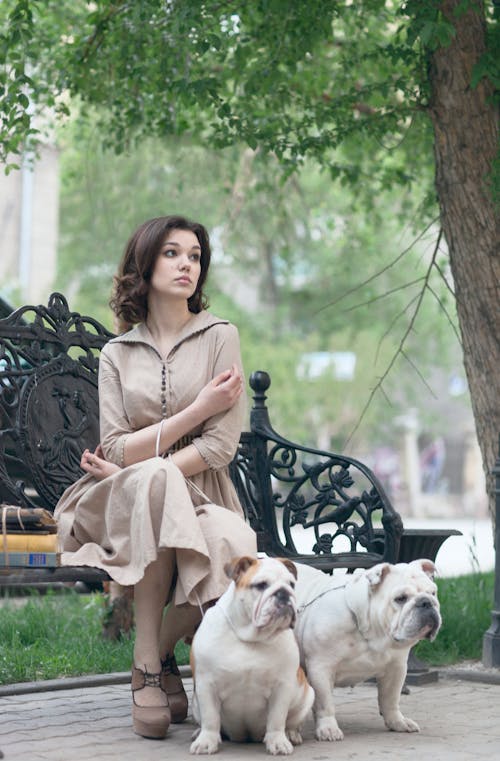 Woman in Brown Dress Sitting on a Bench