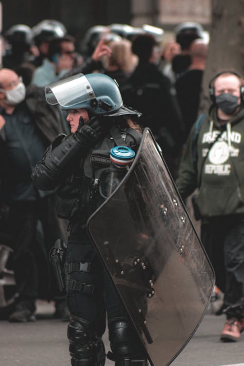 Female police officer maintaining order on protest