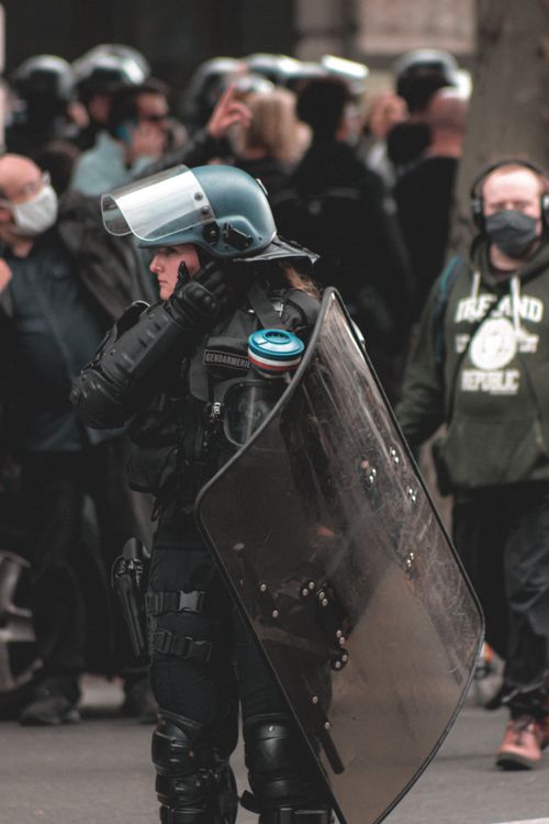 Female police officer maintaining order on protest · Free Stock Photo