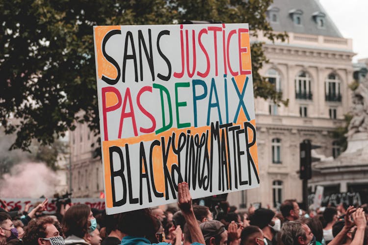 Unrecognizable Person With Sign Marching At Demonstration