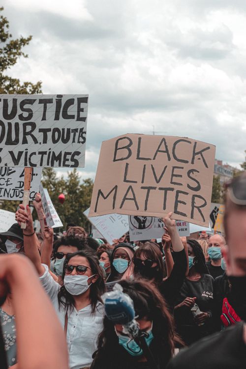 Free Young diverse people in casual clothes and medical masks participating in protest during coronavirus Stock Photo