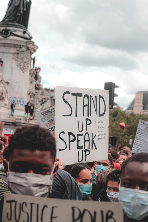 Free Crowds of people protesting racial injustice in Nashville and holding placard sign reading Stand up Speak up Stock Photo