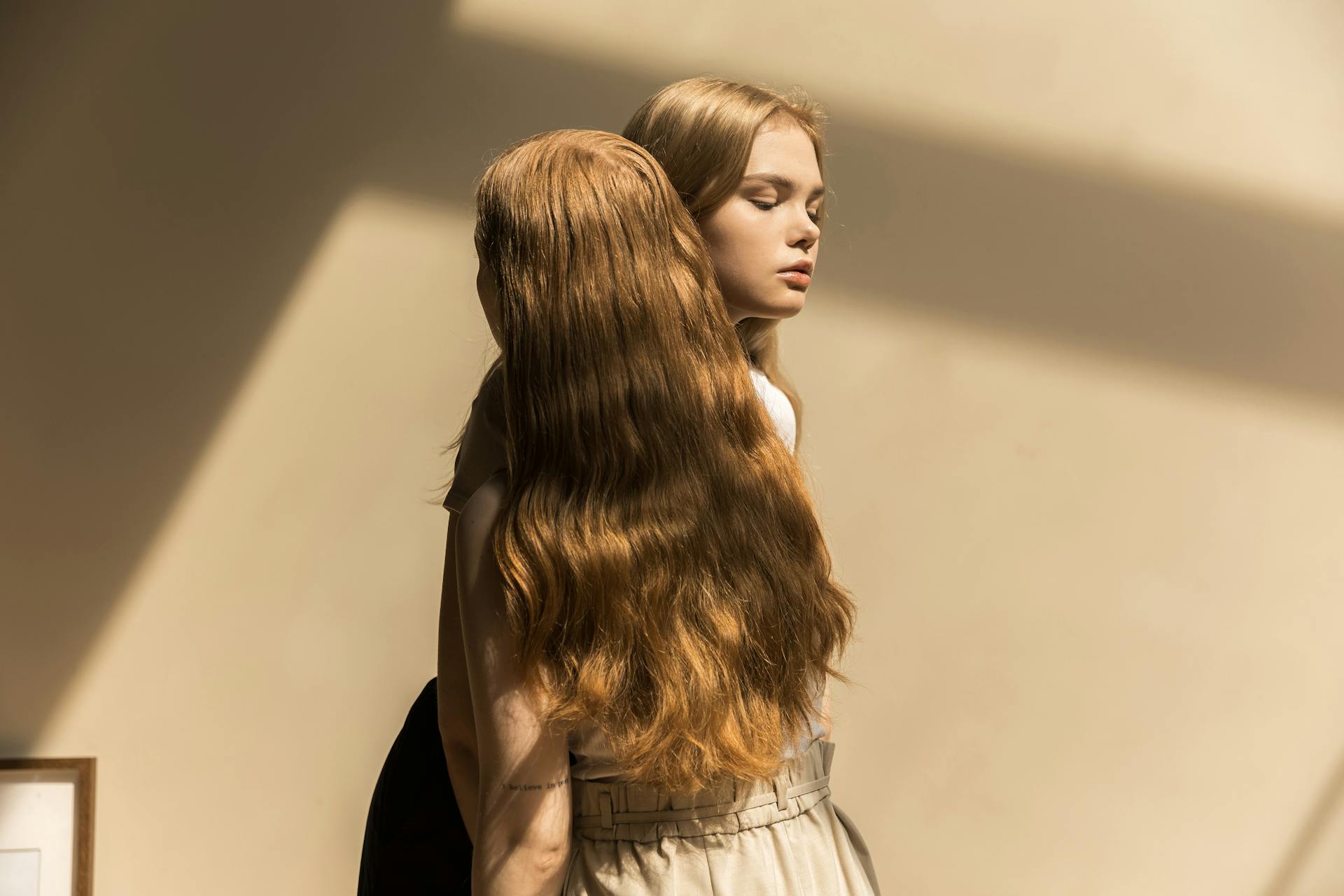 A Person with Long Blond Hair Standing Close to a Woman