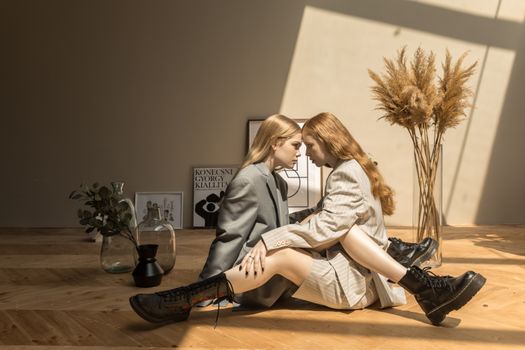 Women Wearing Coat Sitting Down on the Wooden Floor