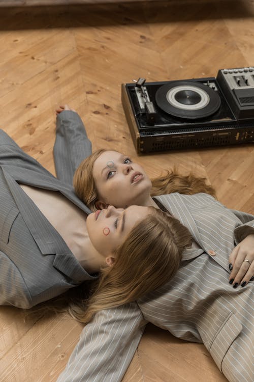Two Women Lying Down on the Floor