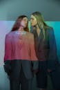 Woman in Black Blazer Beside Woman in Pink Blazer