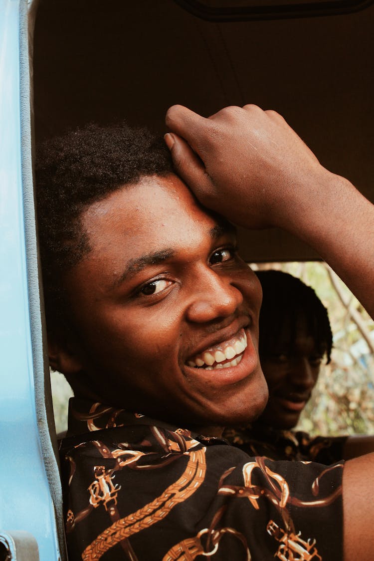 Black Man Sitting In Car And Smiling