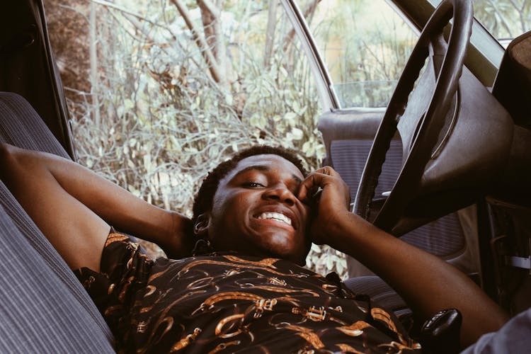 African American Man Resting In Car And Smiling