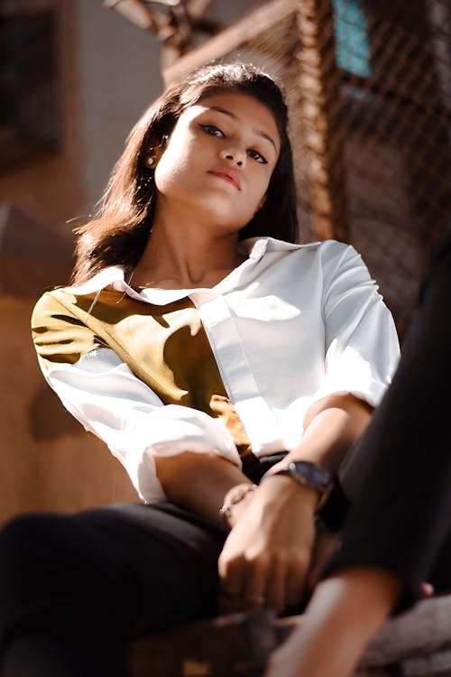 Low Angle Shot of a Woman in White Top