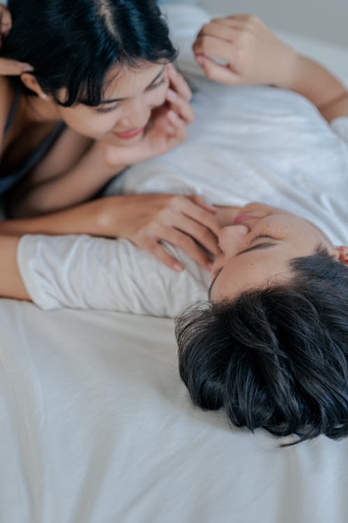 Free Couple Lying on Bed Stock Photo