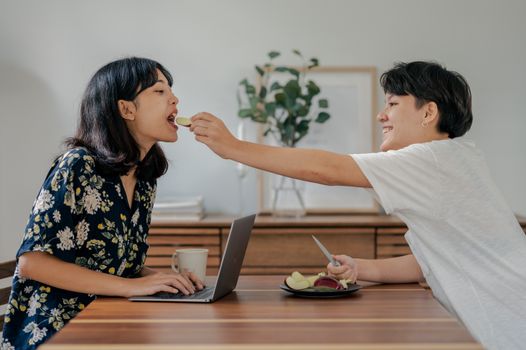 一对开朗的夫妇在家庭办公室里一起享用早餐和咖啡