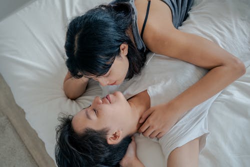 Free Couple Lying Together in Bed Stock Photo