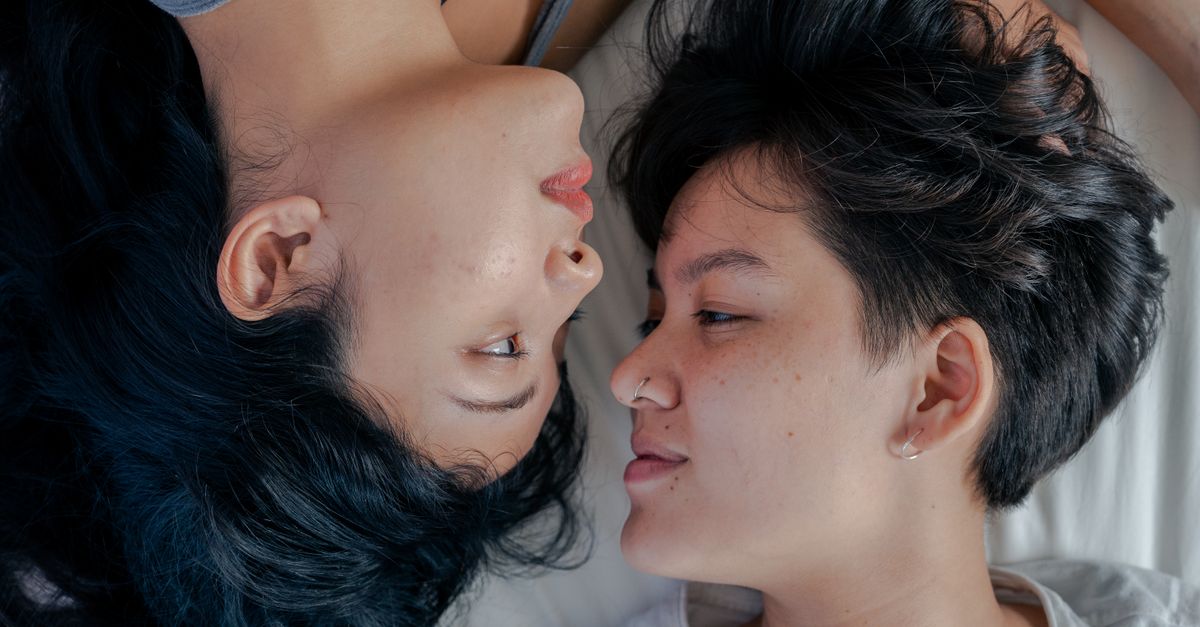Close-up of a loving couple lying side by side, capturing a moment of intimacy.